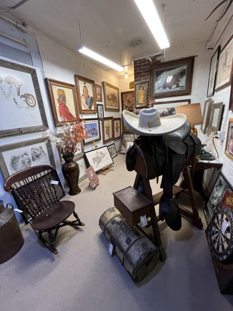 A cozy art gallery corner filled with framed paintings and vintage furniture.